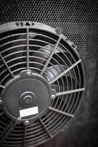 Close up image of the engine cooling fan of a bus.