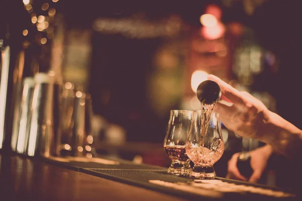 Cantinero vertiendo whisky en un vaso — Foto de Stock