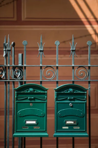 Two vintage green mail boxes