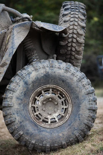 Close up shot of a muddy off road tire on a 4x4 car.