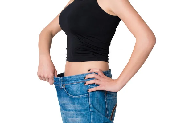 Isolated Woman lost weight and her trousers are too big, healthy lifestyle — Stock Photo, Image