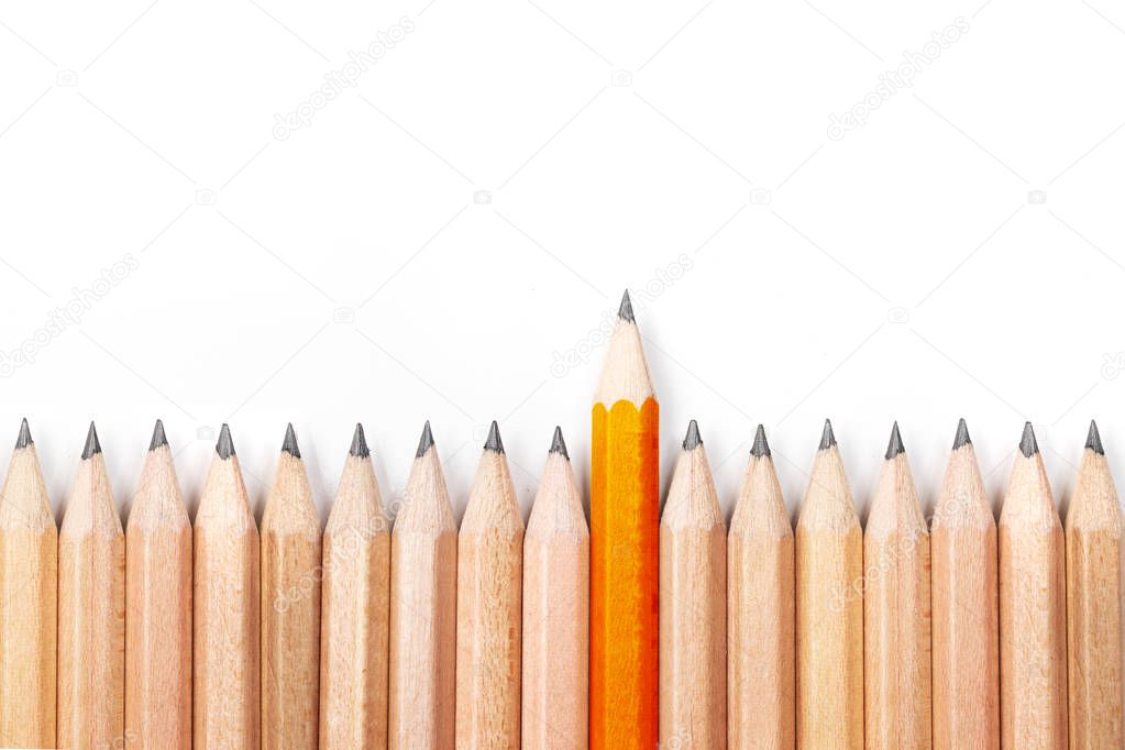 Orange pencil standing out from crowd of black pencils on white background.Concept of leader,unique,different