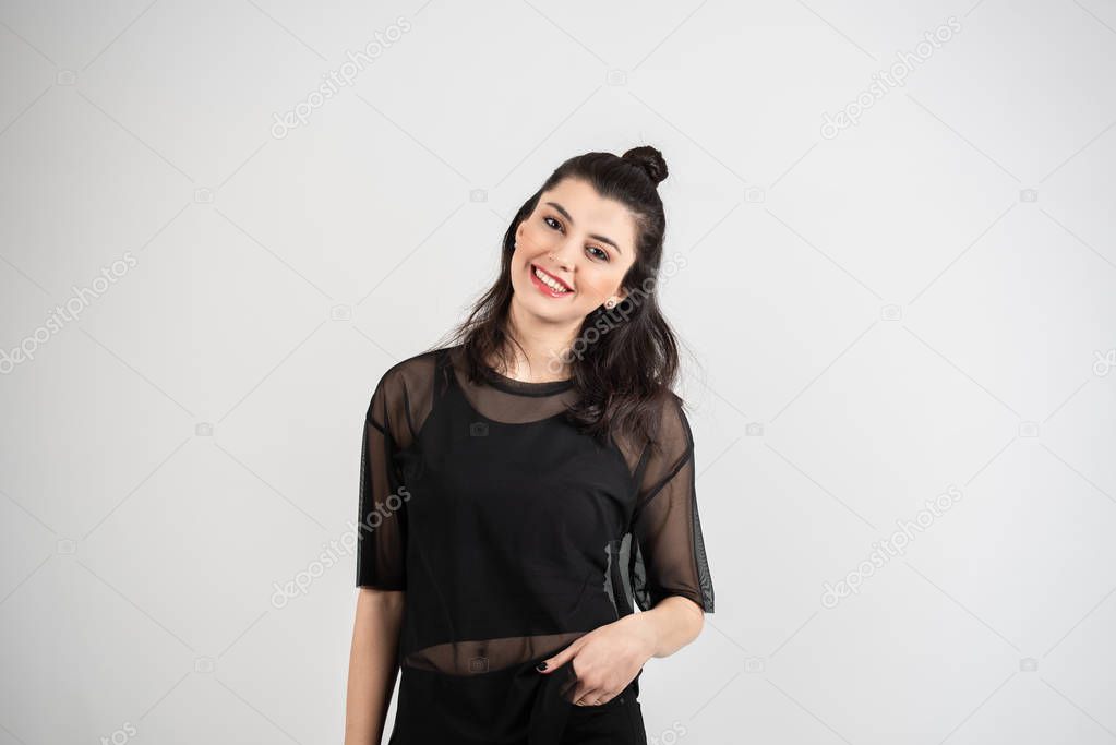 Happy cheerful young woman looking at camera with joyful and charming smile.