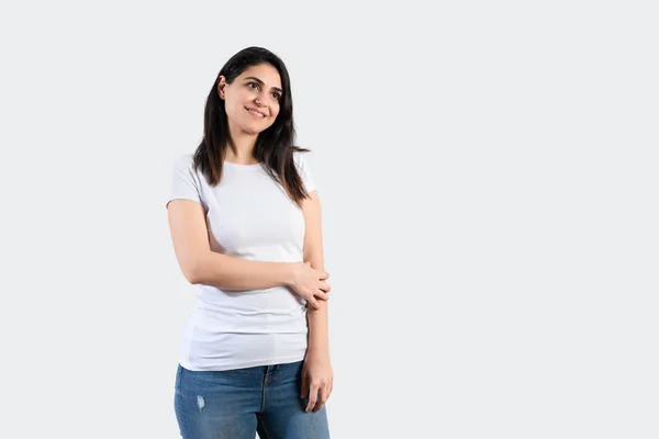 Young girl wearing blank white  t-shirt and blue jeans. Grey wall background — Stock Fotó