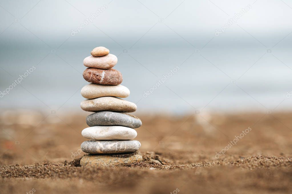 Stack of Stone over the sand. Balance and stability concept with stones.