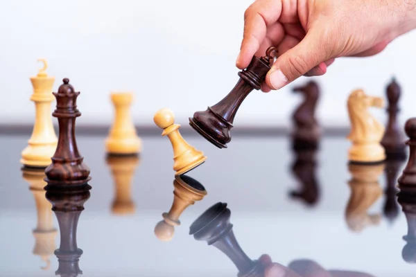 businessman plays chess, concept of business leadership and competition