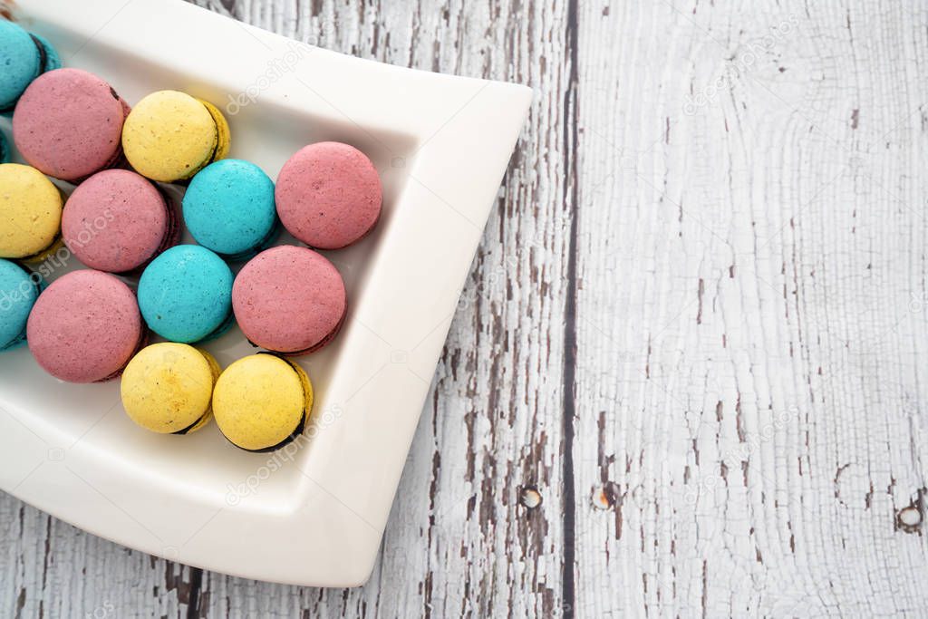 Tasty and colorful macaroons for special days on wooden table