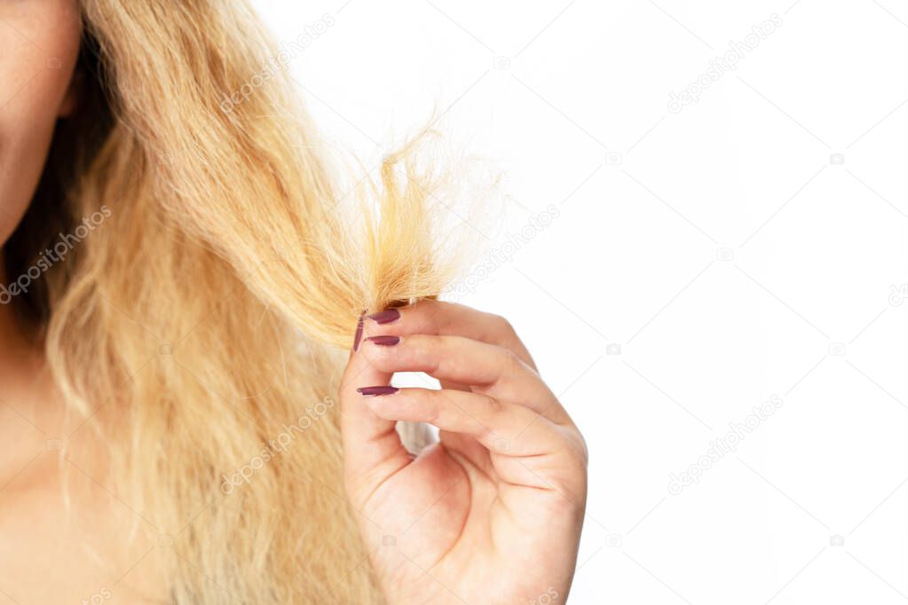 Young woman holding hair, decide to hair care