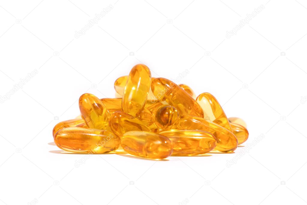 A pile of yellow collered medicine on a white background