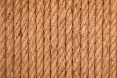 Kahverengi kıvrılmış halat. Kahverengi ve sarı ipli arka plan. Arkaplan için ip deseni.