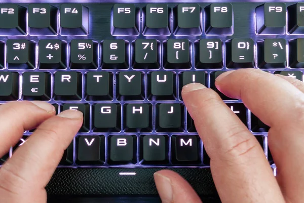 Closeup view of a keyboard with bright led lights for easy and comfortable using pc or notebook. High Tech concept. — Stock Photo, Image