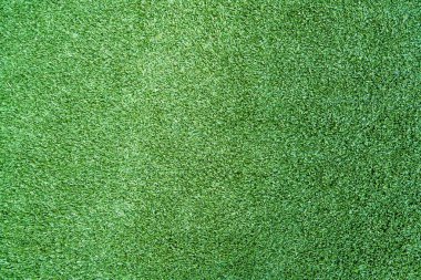 Yeşil çimlerin ya da yukarıdaki çimlerin yakın görüntüsü, bir oyun alanı ya da alan. Desen ve Doku Konsepti.