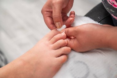 Pedikür tedavisi sırasında sahte ayak tırnağı takmak. Yüksek kalite fotoğraf