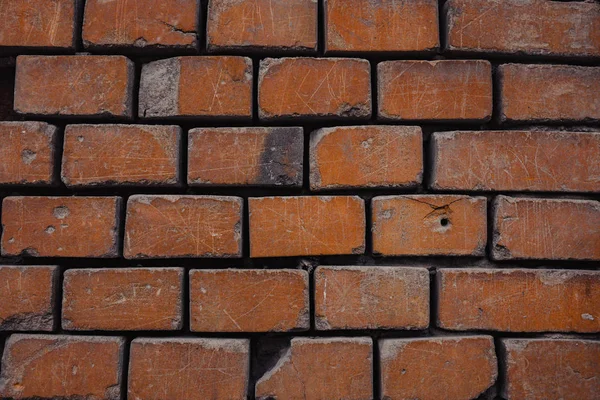 A crumbling red brick wall brick background. — Stock Photo, Image