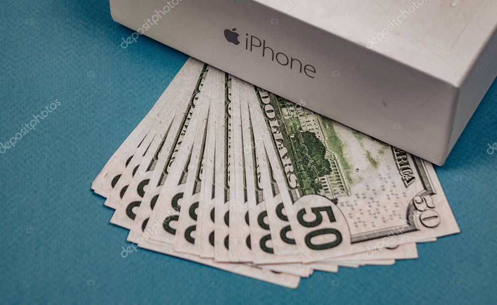 Voronezh Russia - may 3, 2019. Apple Inc. logo and fifty dollar bills on the blue background
