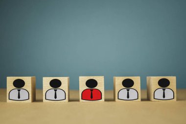 wooden cubes in the form of bosses and subordinates, personnel subordination on a blue background