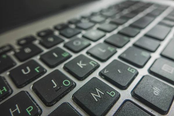 laptop keyboard close-up in two languages: Russian and English