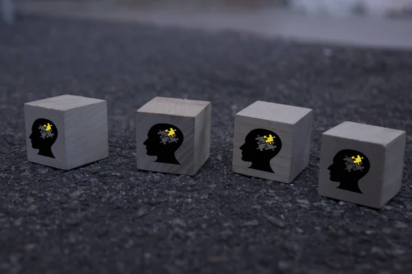 Cubes dice with heads, question marks and lightbulb on wooden background