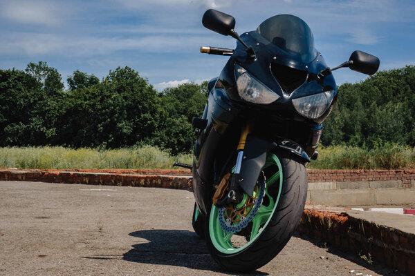 sport bike black with green rims front view