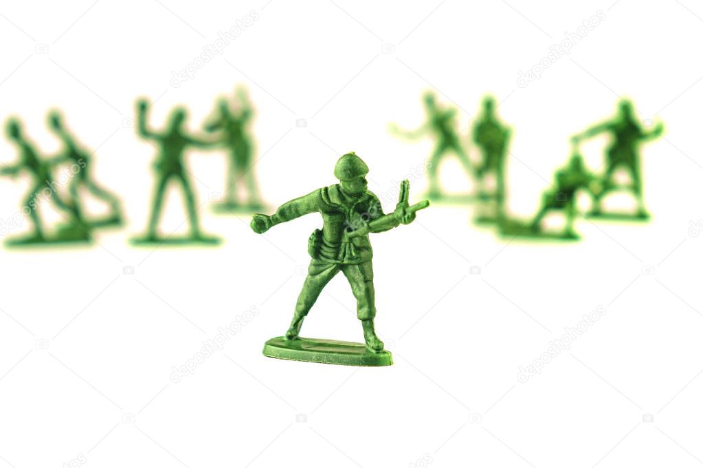 lot of plastic toy soldiers on white background.