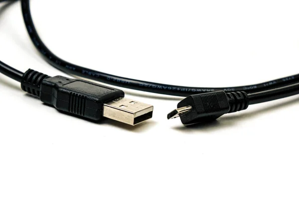 나무 테이블에 넣어 마이크로 USB 검은 케이블, 그것은 작고 짧은 휴대성을 위해. 흰색 배경에 격리. — 스톡 사진