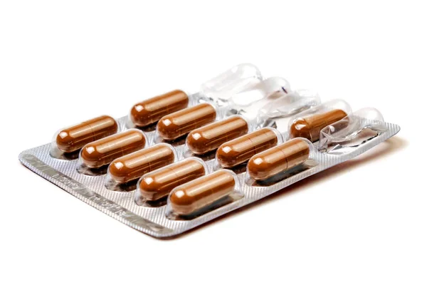 Brown tablets in a package isolated on a white background — Stock Photo, Image