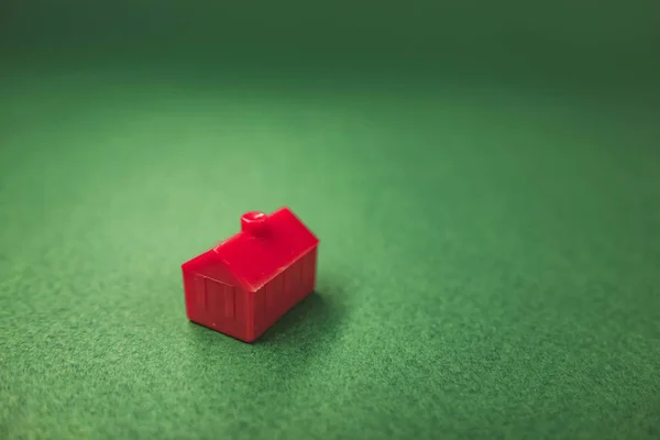small red house isolated on green background