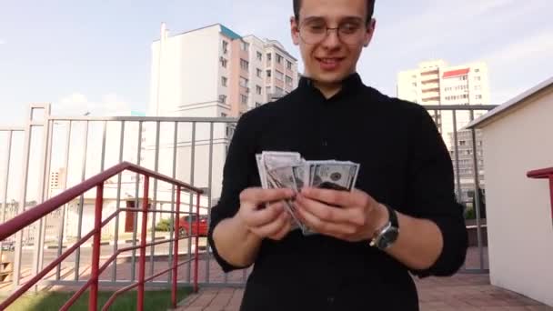 Guy dalam gerakan lambat berjalan di jalan dan menghitung uang — Stok Video