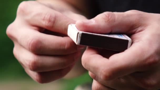 un homme allume une allumette dans la rue.