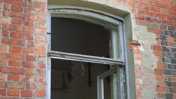 Un edificio abandonado de ladrillo rojo con ventanas rotas. — Vídeos de Stock