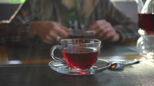 Пара сидит в ресторане и пьет красный чай — стоковое видео