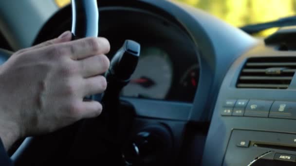 Homem dirige um carro segurando o volante — Vídeo de Stock