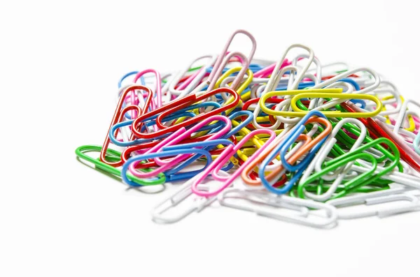 Colorful paper clips to documents lying on a white background — Stock Photo, Image