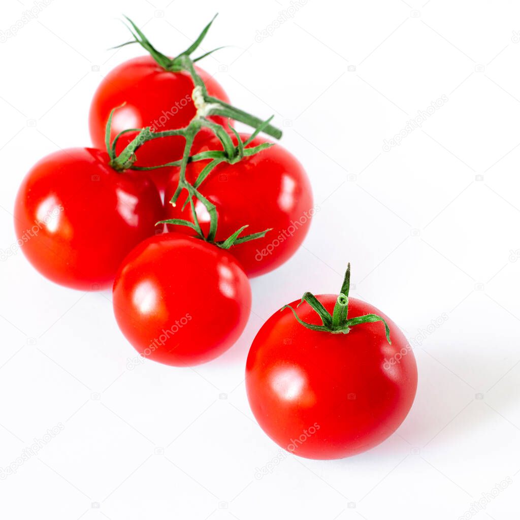 Harvest tomatoes. A branch of cherry tomatoes lies on a white background