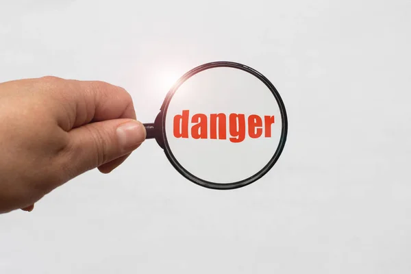 Magnifying Glass Hand Danger Word White Background — Stock Photo, Image