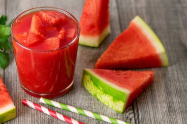 Karpuz yüzlü kavanoz gri ahşap zemin üzerine taze karpuz dilimleri ile.