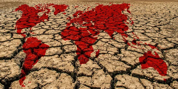 World map on a dried and cracked soil.