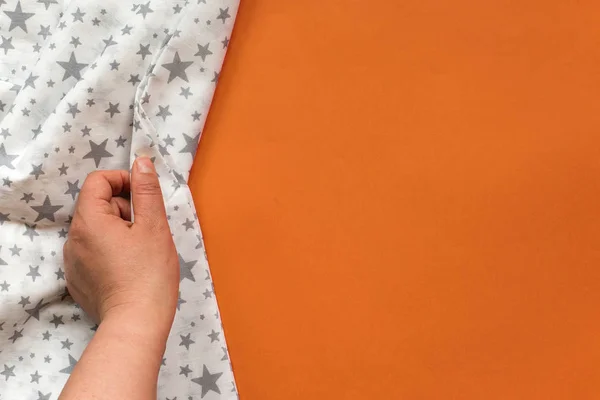 Female Hand Touching White Cloth Orange Background Copy Space — Stock Photo, Image