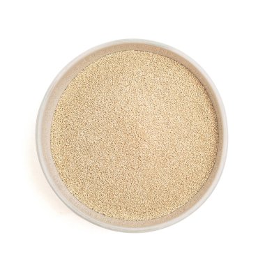 dry yeast in bowl isolated on white background. Top view.