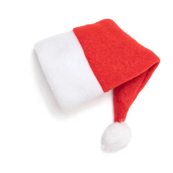Na bílém pozadí Santa Claus udělal červený klobouk. Pohled shora Stock Obrázky