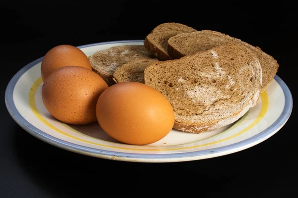 Rye bread covered with mold and chicken eggs.