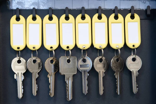 Hanging keys in metal cabinet for safety office or household keys management and keeping. keys with blank name tags, space for text