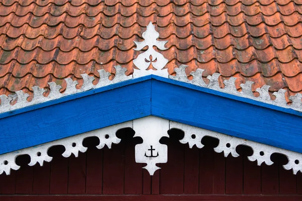 The hook - handmade decoration on fisherman\'s house. White, orange and blue colors