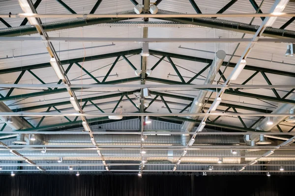 Factory building or warehouse building. Vast empty space with ventilation pipes and lights