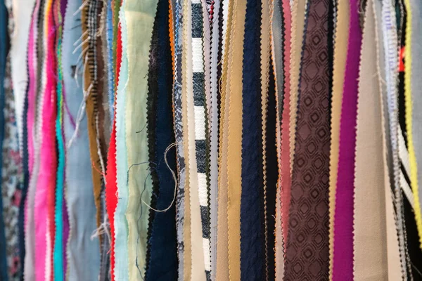 Fabric and textiles samples in a factory shop or store. Different colors and patterns on the market. Industrial fabrics.