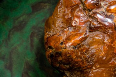 Macro Close up of an amber stones from Baltic sea. Multicolored background for advertising and banners. Vintage fossilized resin as a background. Yellow amber texture close up. Stone with inclusions