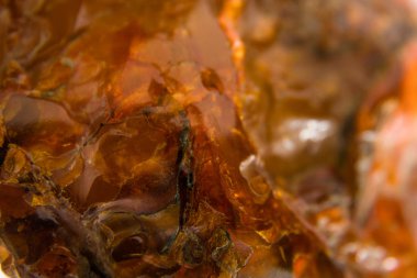 Macro Close up of an amber stones from Baltic sea. Multicolored background for advertising and banners. Vintage fossilized resin as a background. Yellow amber texture close up. Stone with inclusions
