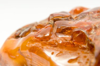 Macro Close up of an amber stones from Baltic sea. Multicolored background for advertising and banners. Vintage fossilized resin as a background. Yellow amber texture close up. Stone with inclusions
