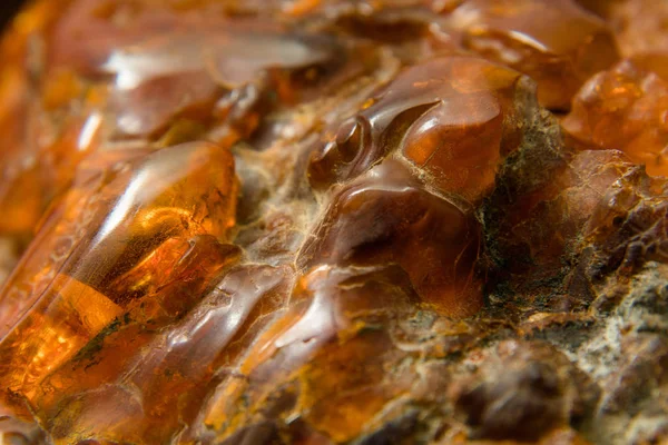Macro Close up of an amber stones from Baltic sea. Multicolored background for advertising and banners. Vintage fossilized resin as a background. Yellow amber texture close up. Stone with inclusions