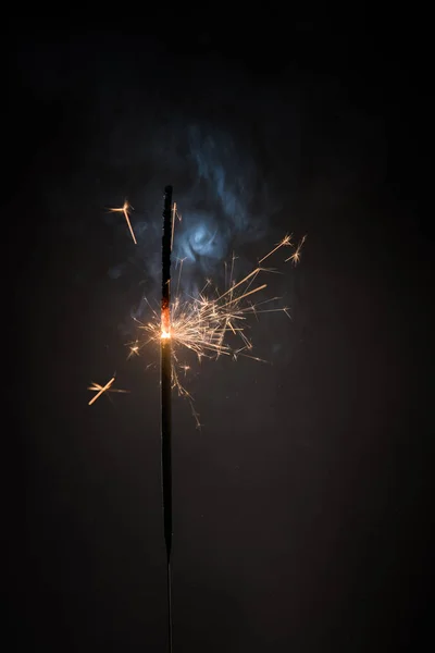 Burning bengal fire stick New year sparkler candle isolated on black background. Realistic sparkler. Magic light stick. Christmas decoration